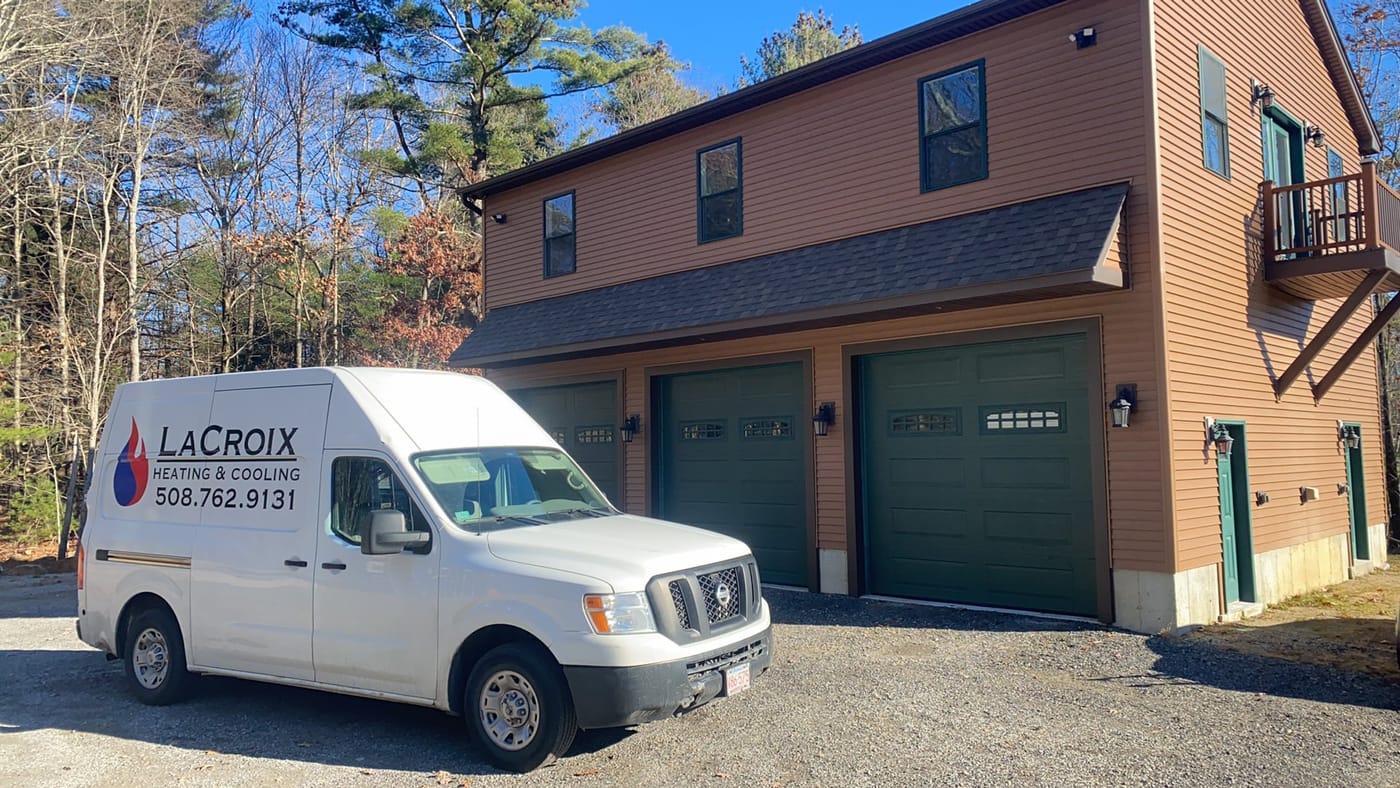 LaCroix Heating and Cooling service van parked outside the company's garage